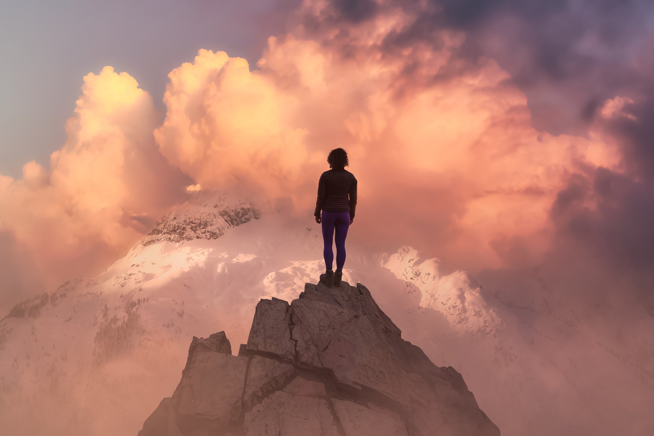 Woman on Top of a Mountain Peak